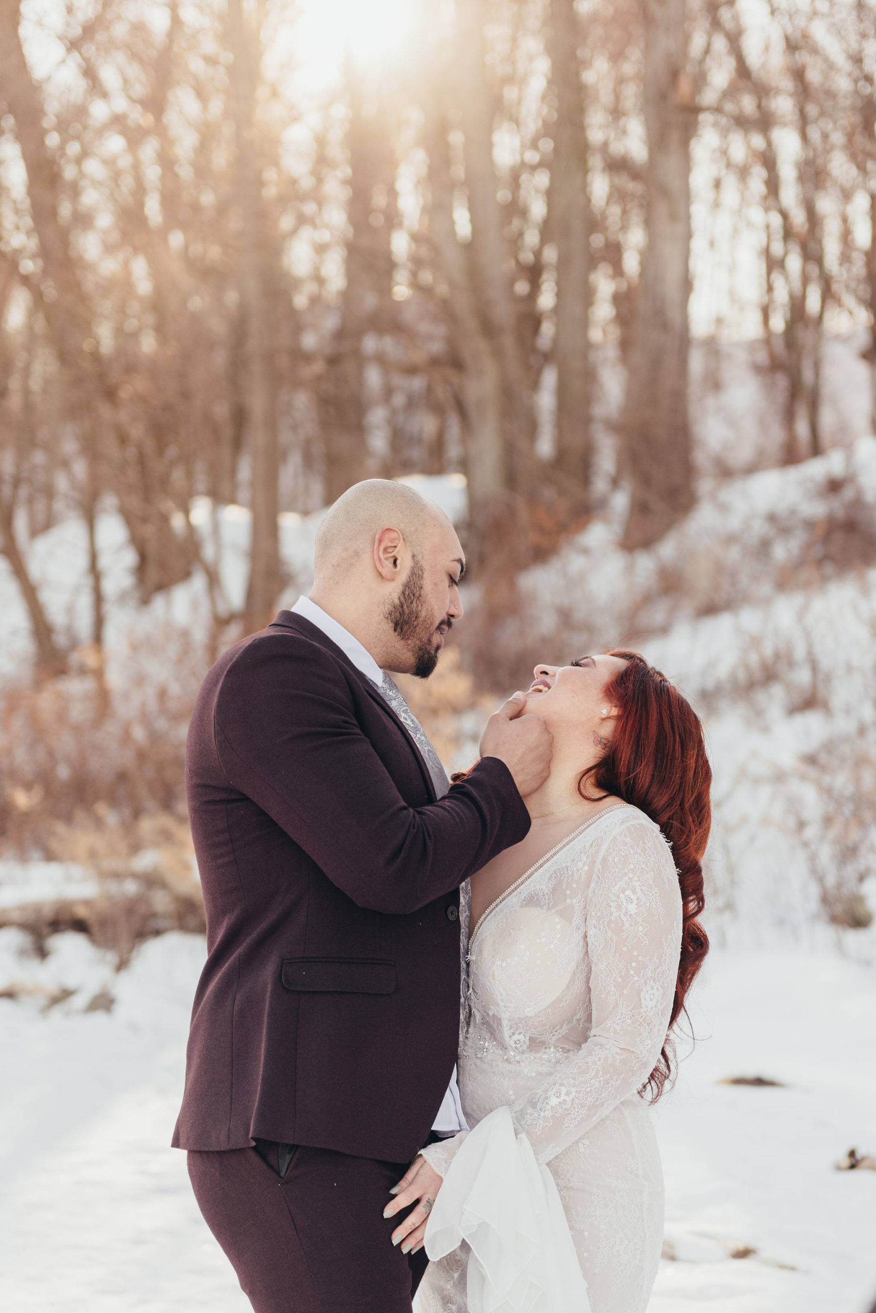 bride and groom looking at eachother and posing in a winter forest