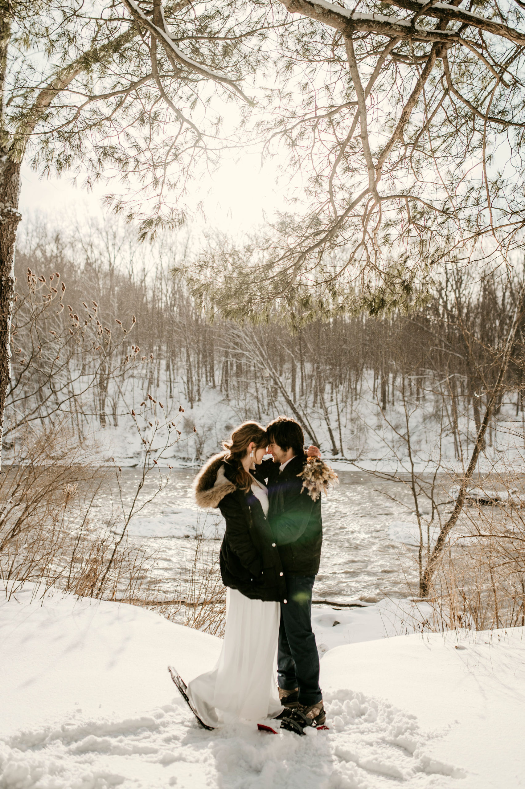 bride and groom hugging and kissing in the snow | Tips For Your New York Winter Engagement or Elopement