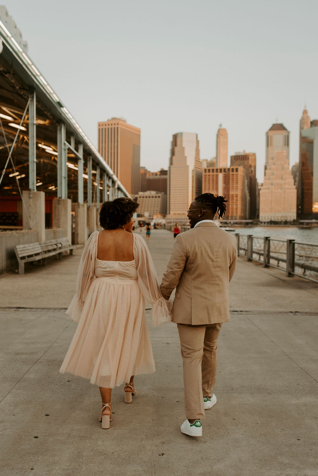 couple walking away from camera holding hands in new york