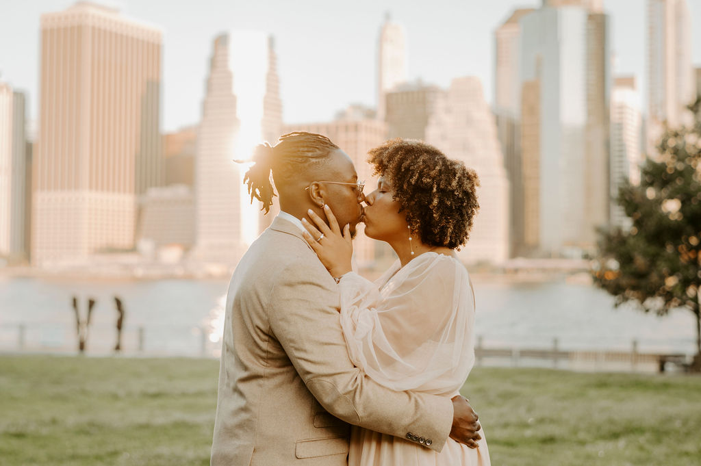 couple walking through new york park posing and kissing