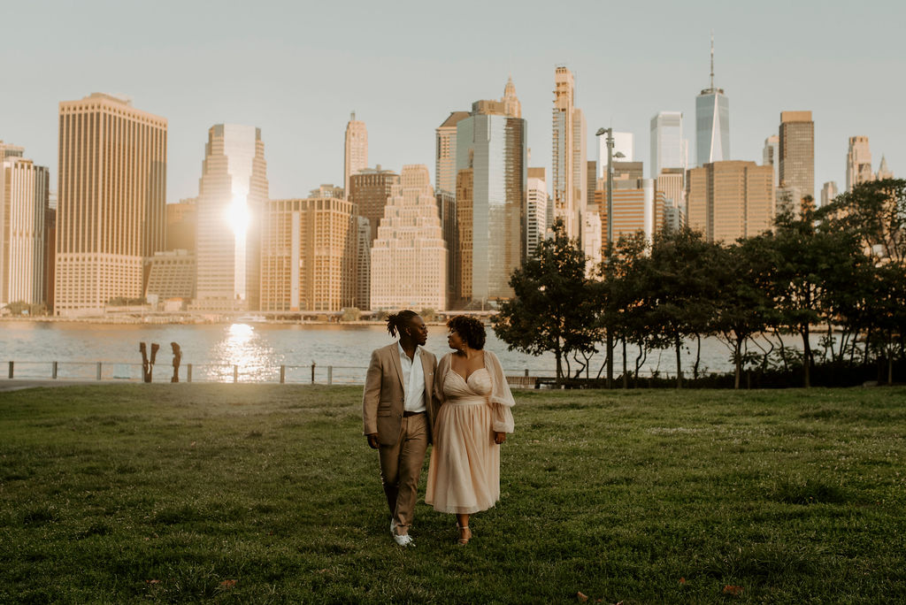 couple walking through new york park posing and kissing