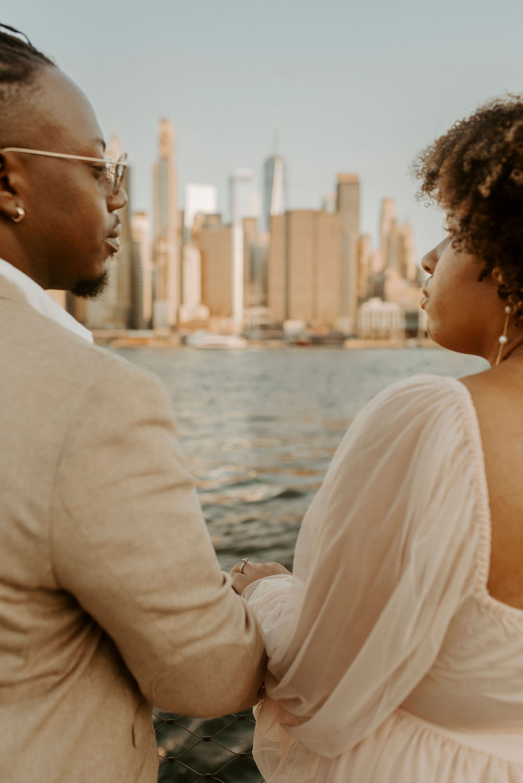 couple looking at eachother with new york city in the background