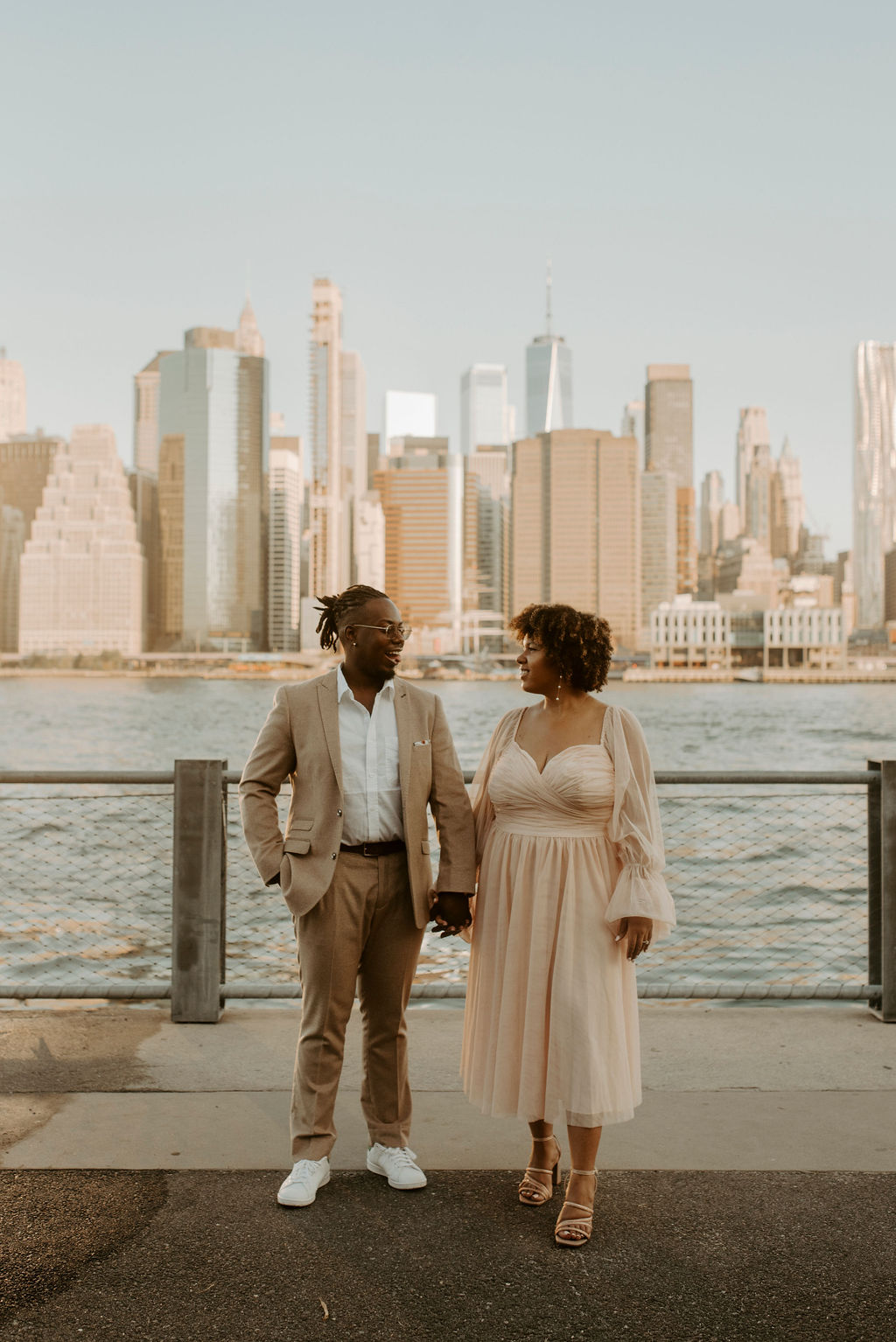 couple holding hands and looking at eachother in new york