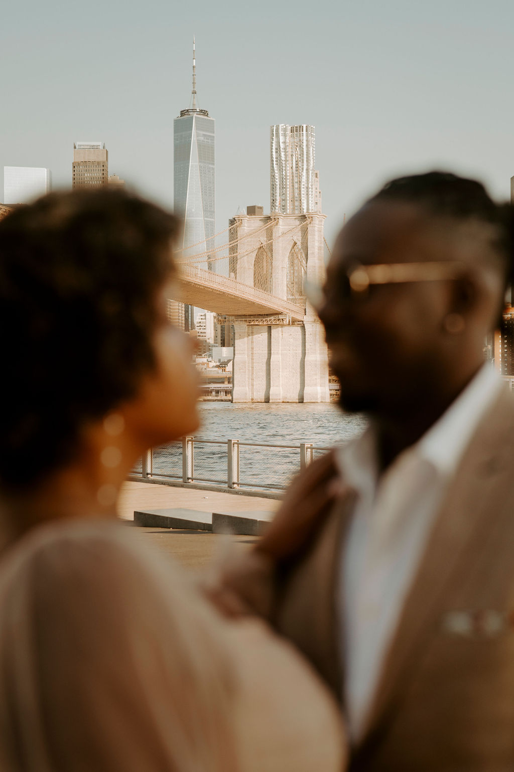 a blurred picture of a couple with the focus on new york city skyline
