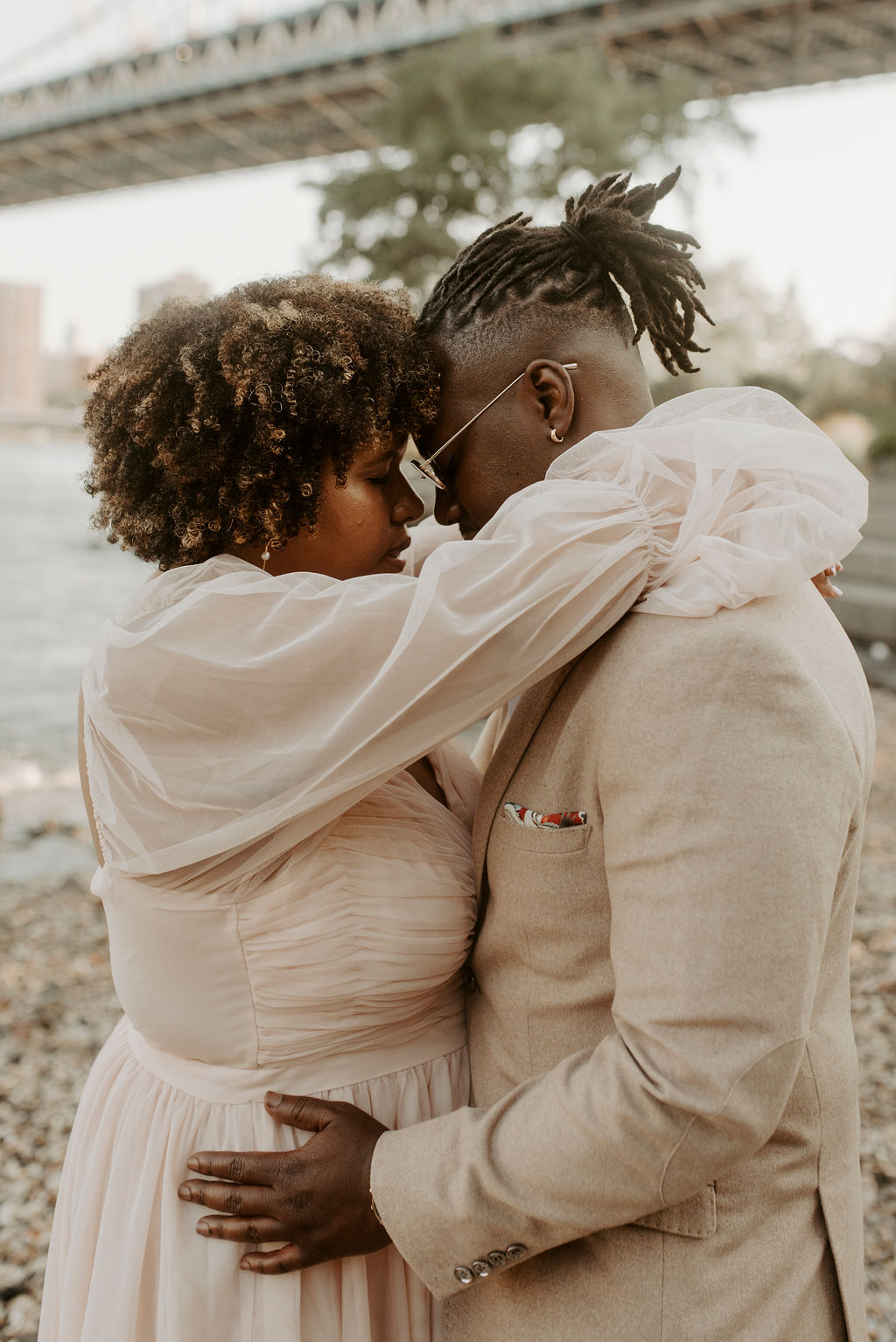 couple hugging near a river in new york