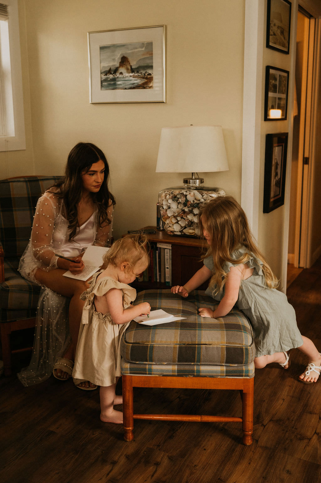 Bride writing vows and daughters helping to make it look nicer.