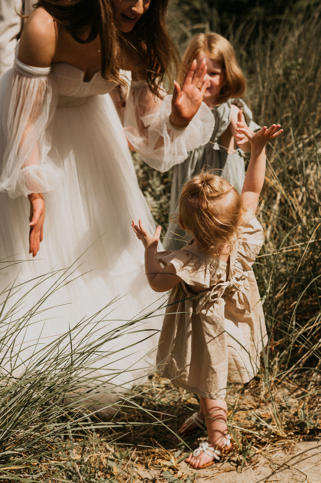 Bride and daughter doing a high five after ceremony. 