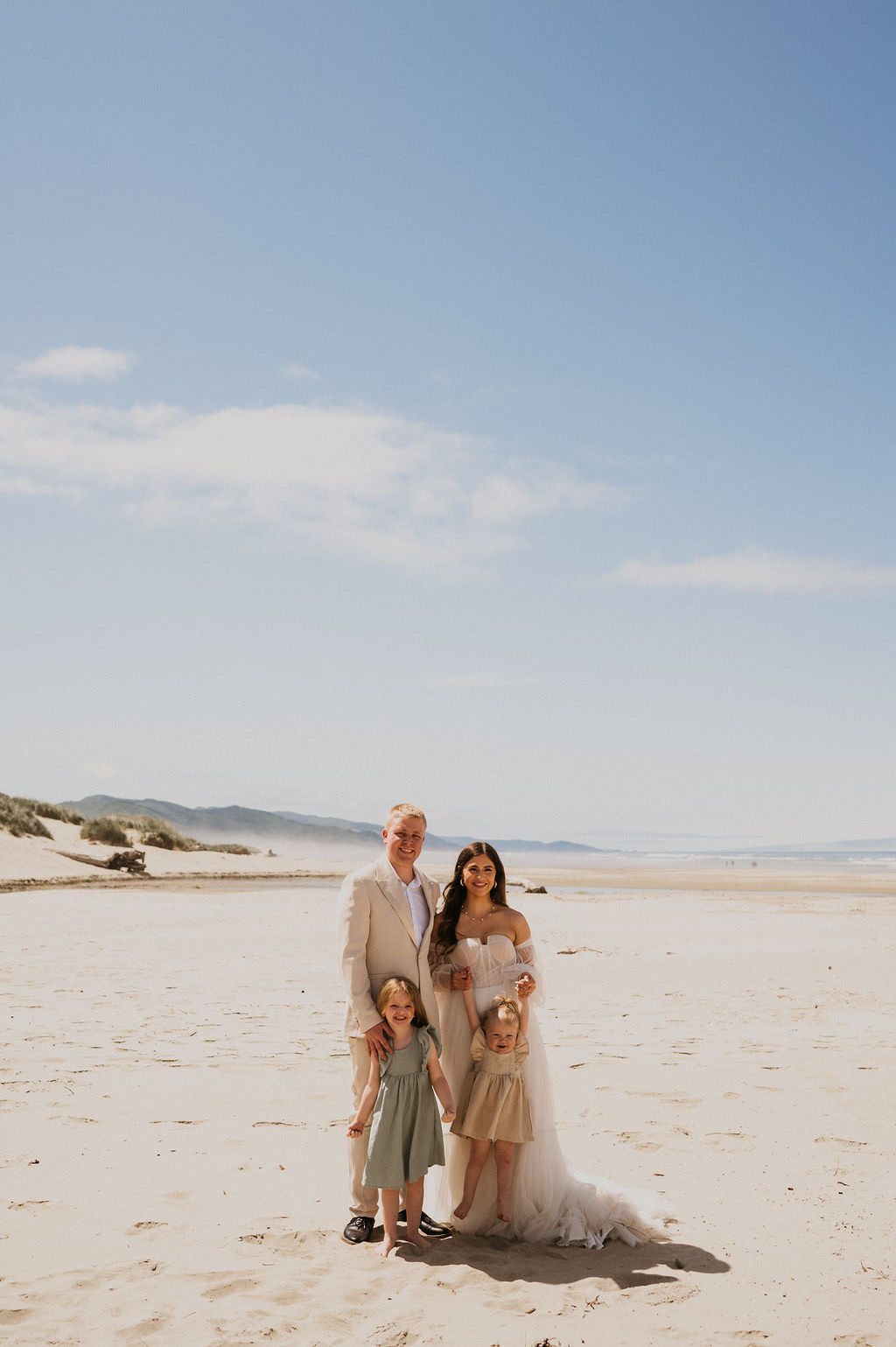 Bride and Groom at their intimate beach elopement with their kids.