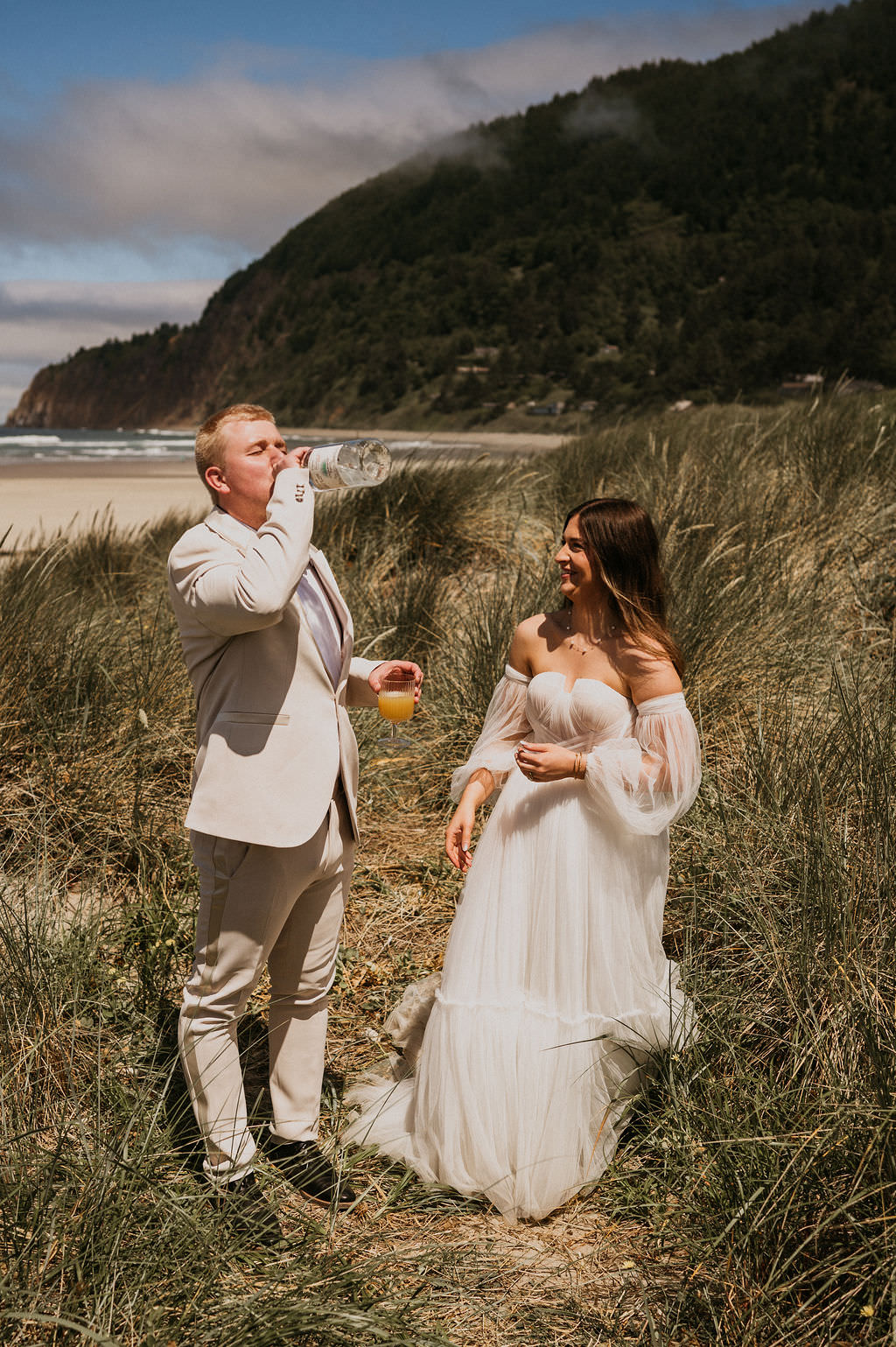 Bride and Groom during their intimate beach elopement drinking their favorite drink. 