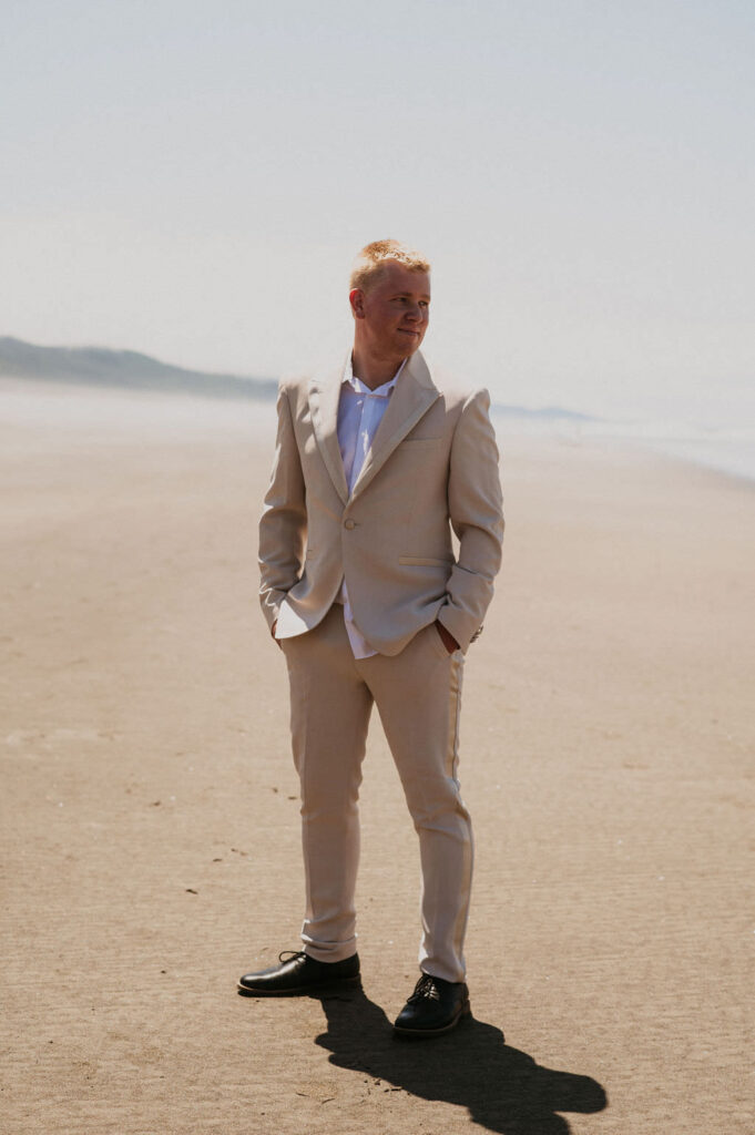 Groom with his suit at his beach elopement.