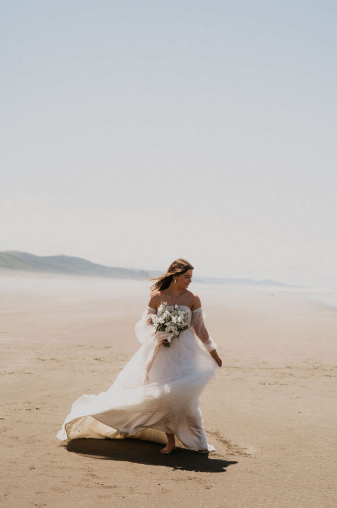 Bride with her gown at her beach elopement.