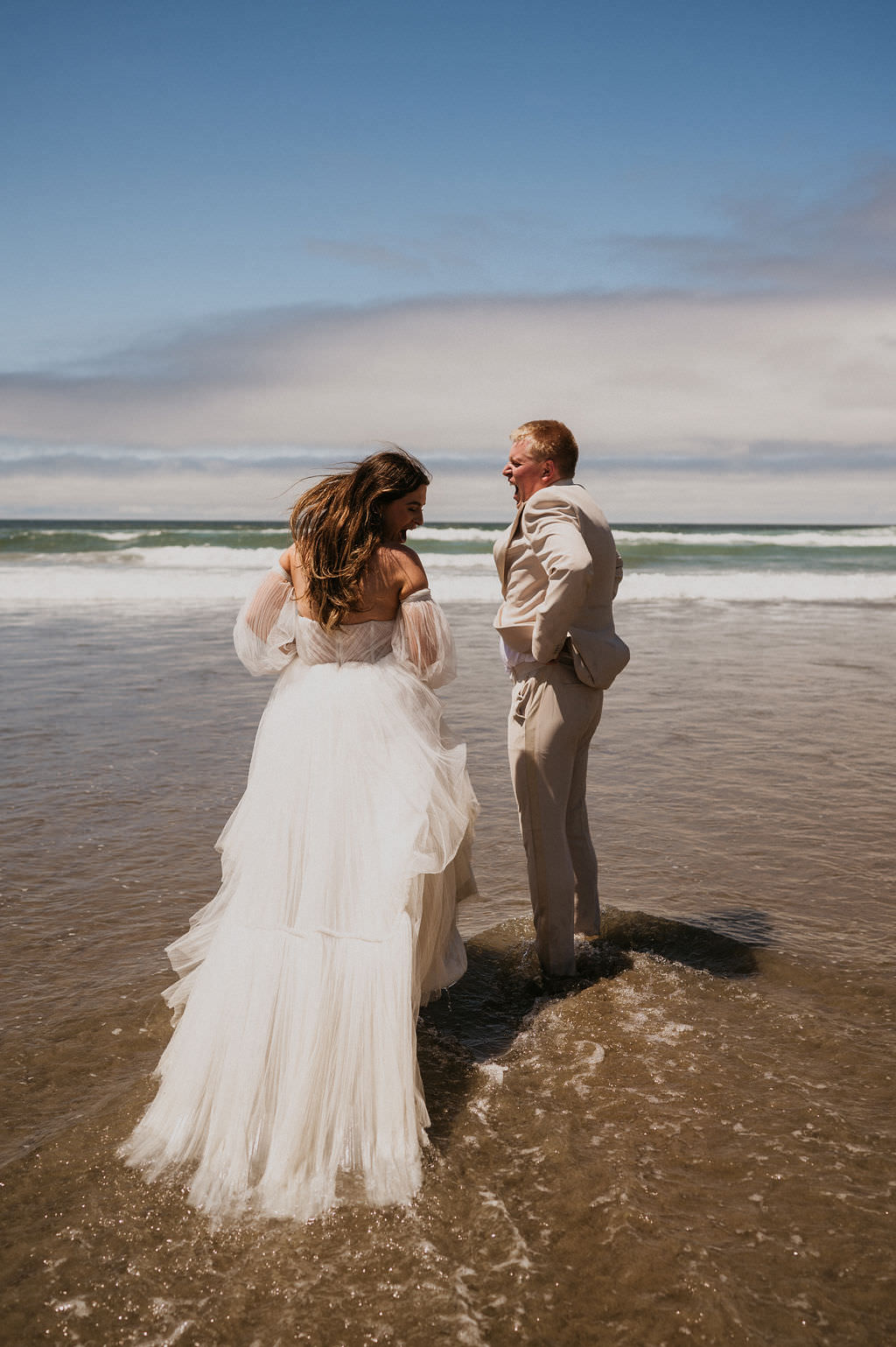 Bride and Groom in their beach elopement in the water.