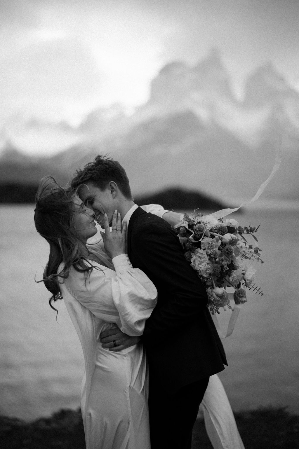 Candid black and white bride and groom kiss during their adventure elopement in Argentina.