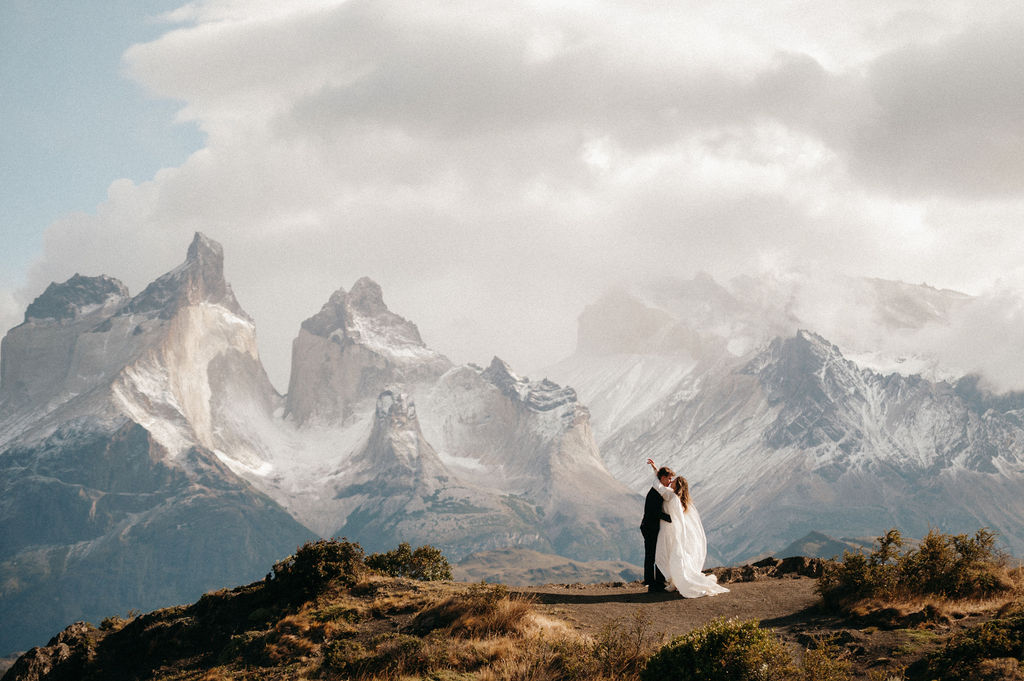 Couple exchanging vows at sunrise elopement on a Patagonia cliffside.