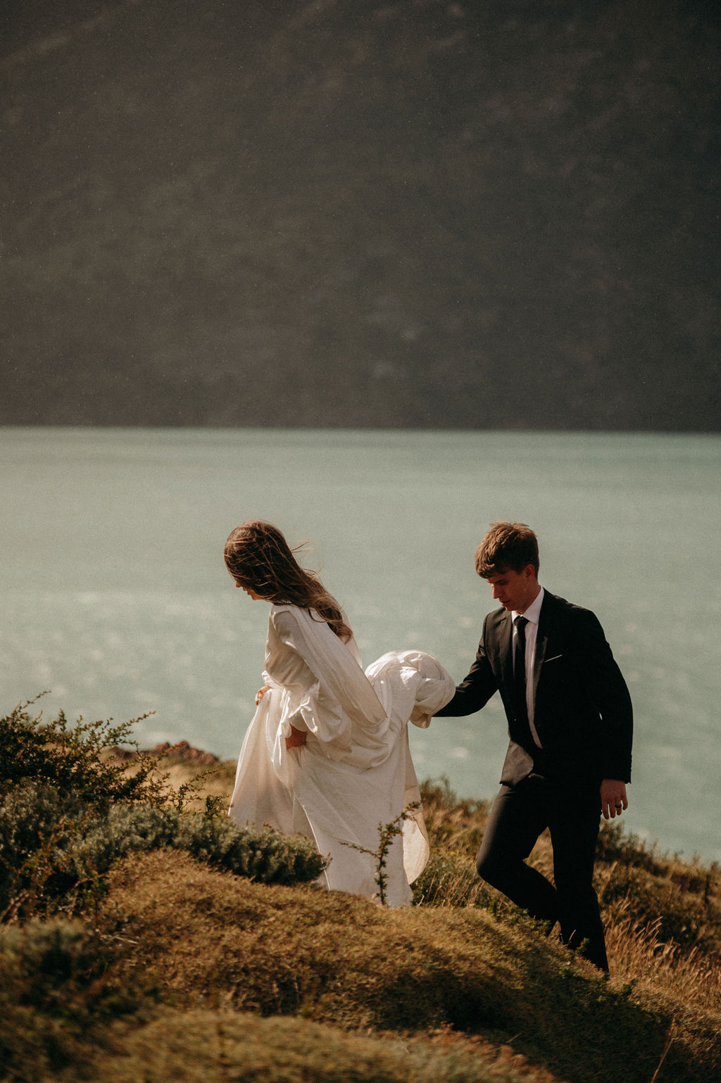 Bride and groom hiking after their Patagonia lake elopement.