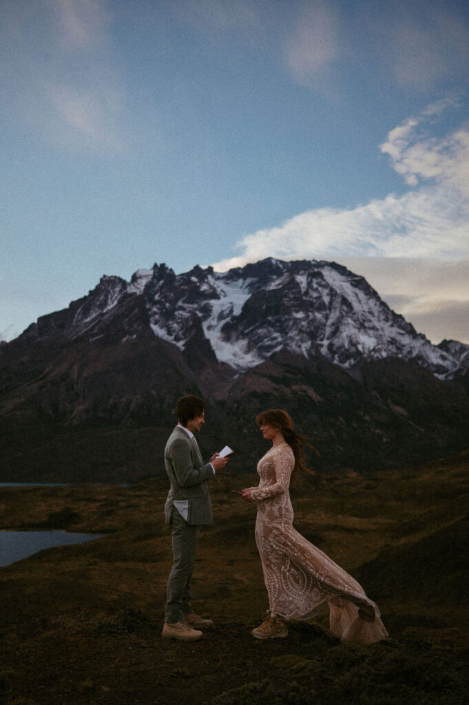 Couple reading their vows during their symbolic ceremony in Patagonia | How to legally elope in Argentina.