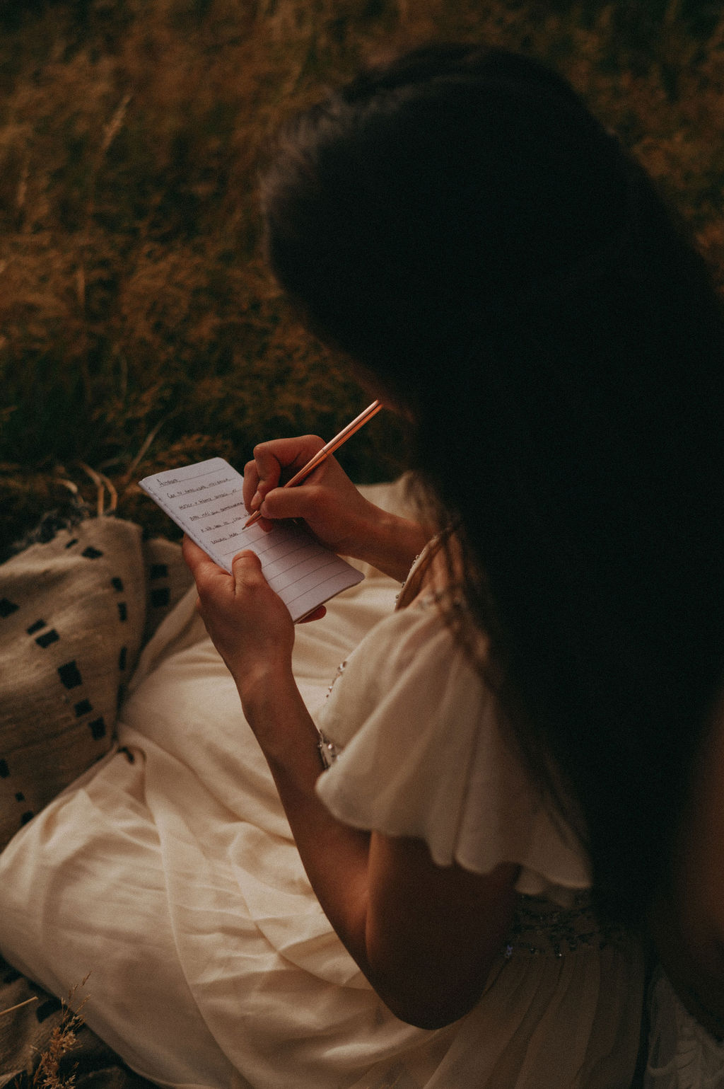 Bride writing her vows in a vow book during her Patagonia elopement, highlighting personal and meaningful elopement activities in a natural setting.