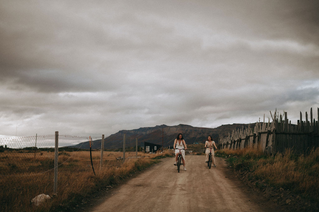 Couple riding bikes before their intimate Patagonia elopement. Elopement activities for adventurous couples.