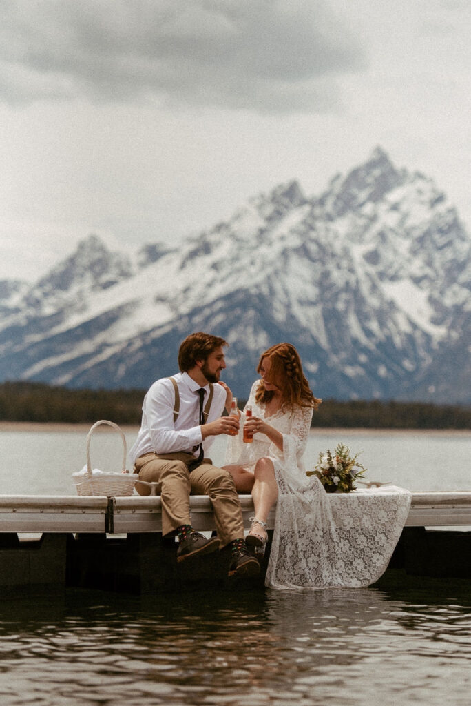 Couple sharing a beer on a dock during their adventure wedding in Patagonia.