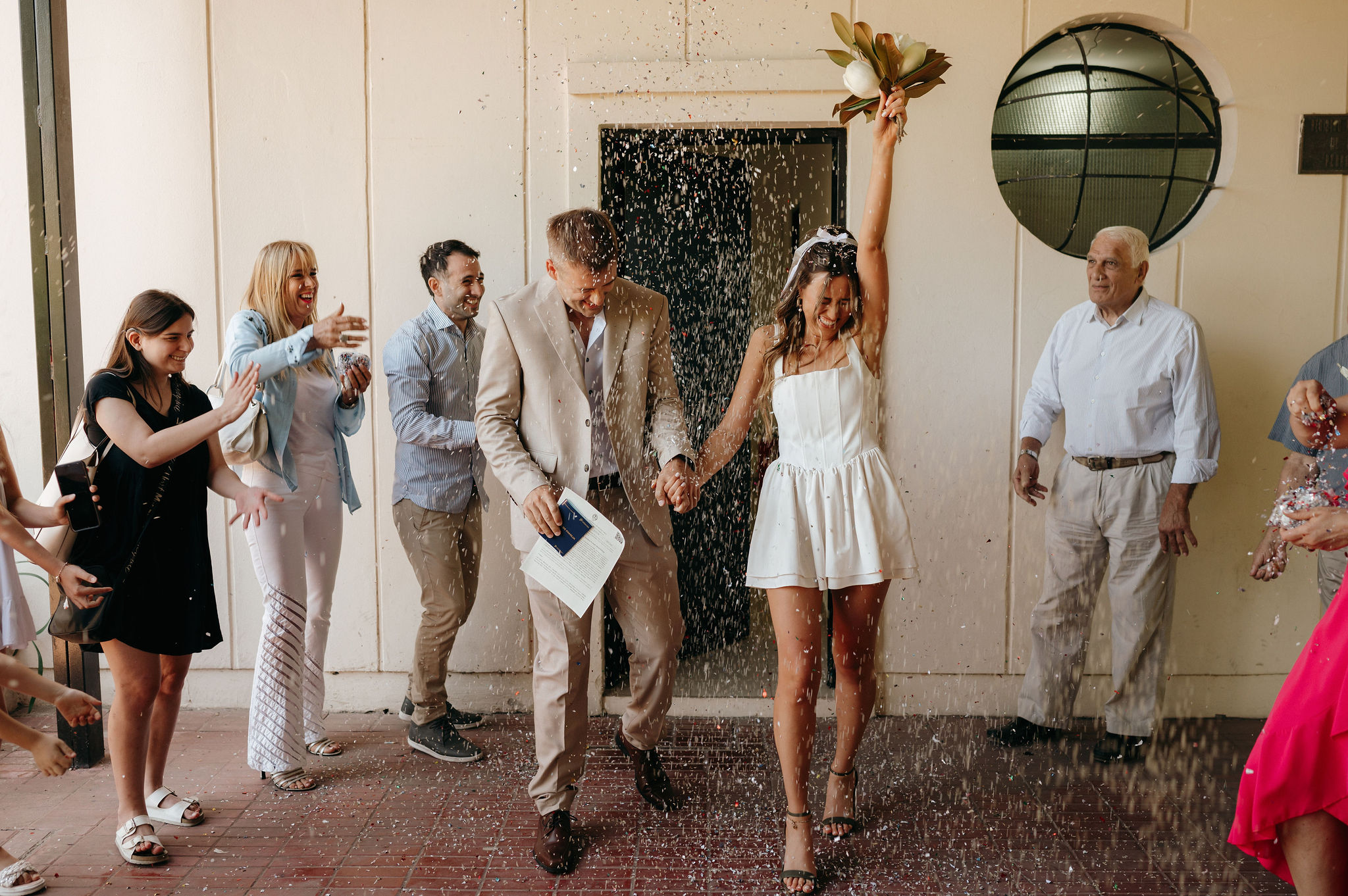 Confetti toss candid moment at a city hall elopement, captured by destination elopement photographer Nicole Adrianna.
