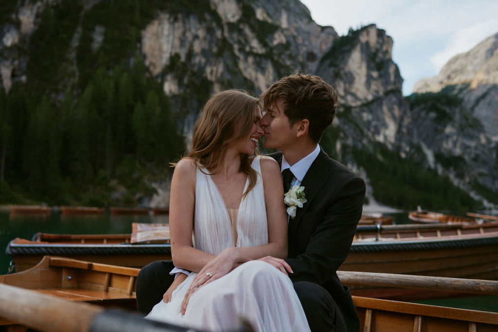 Couple sharing a candid moment on a boat during their Italy elopement, captured by destination elopement photographer Nicole Adrianna.