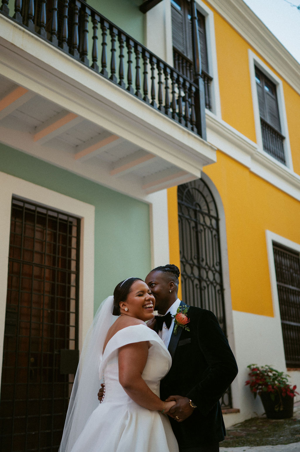 Couple sharing a candid kiss outside their elopement venue.